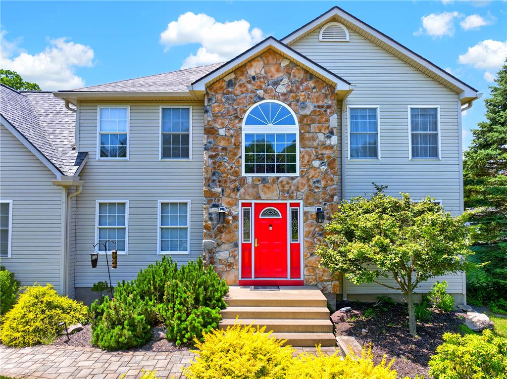 220 Pennbrook Road Stroudsburg, PA 18360 - Photo 2 of 60 A welcoming stone and siding facade with a vibrant red entry door defines this attractive residence.