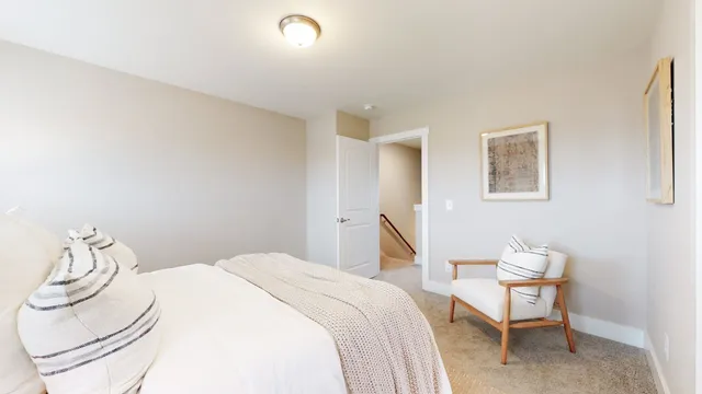 a bedroom with a bed and chair