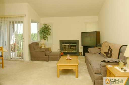 437 Edpas Road New Brunswick, NJ 08901 - Photo 2 of 8 a living room with furniture fireplace and a flat screen tv