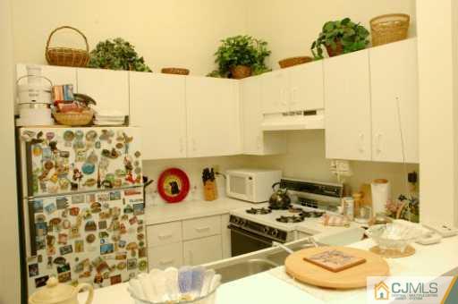 437 Edpas Road New Brunswick, NJ 08901 - Photo 4 of 8 a bathroom with a sink and a mirror