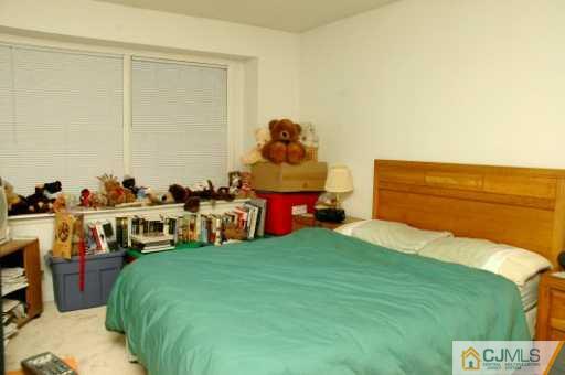 437 Edpas Road New Brunswick, NJ 08901 - Photo 6 of 8 a bed room with a bed and a chair