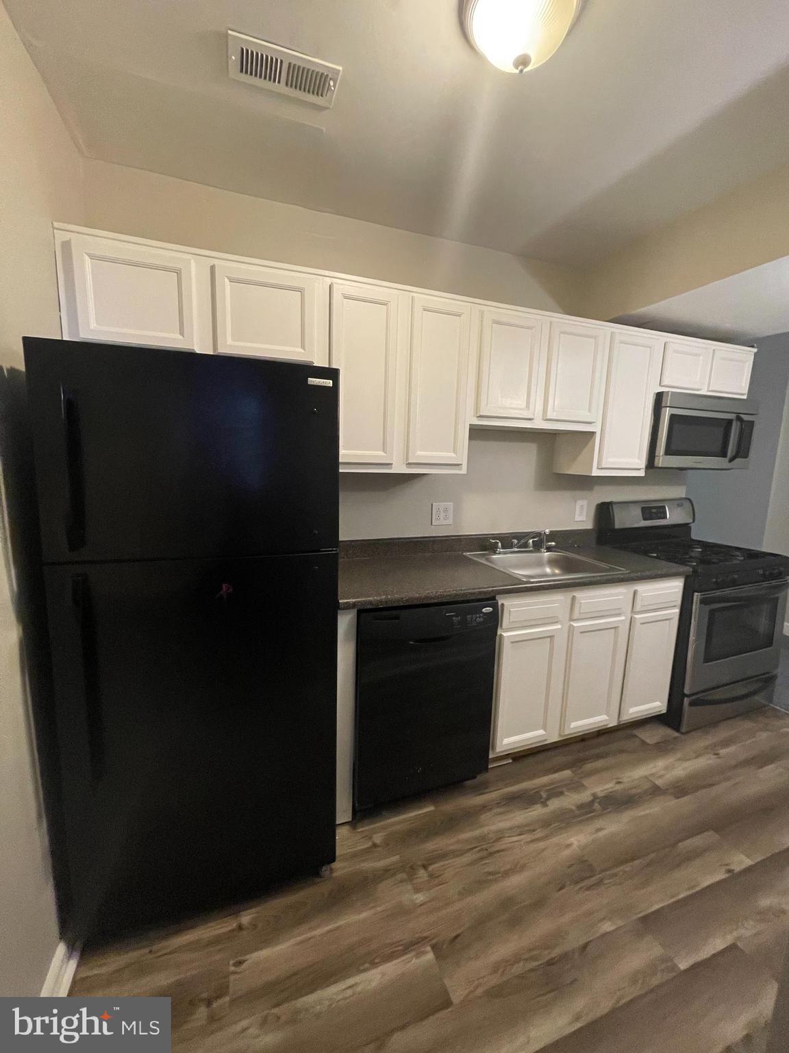 1426 McCulloh Street, Unit 2 Baltimore, MD 21217 - Photo 15 of 25 a kitchen with a refrigerator and a stove