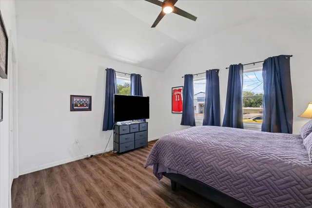 a bedroom with a bed and wooden floor