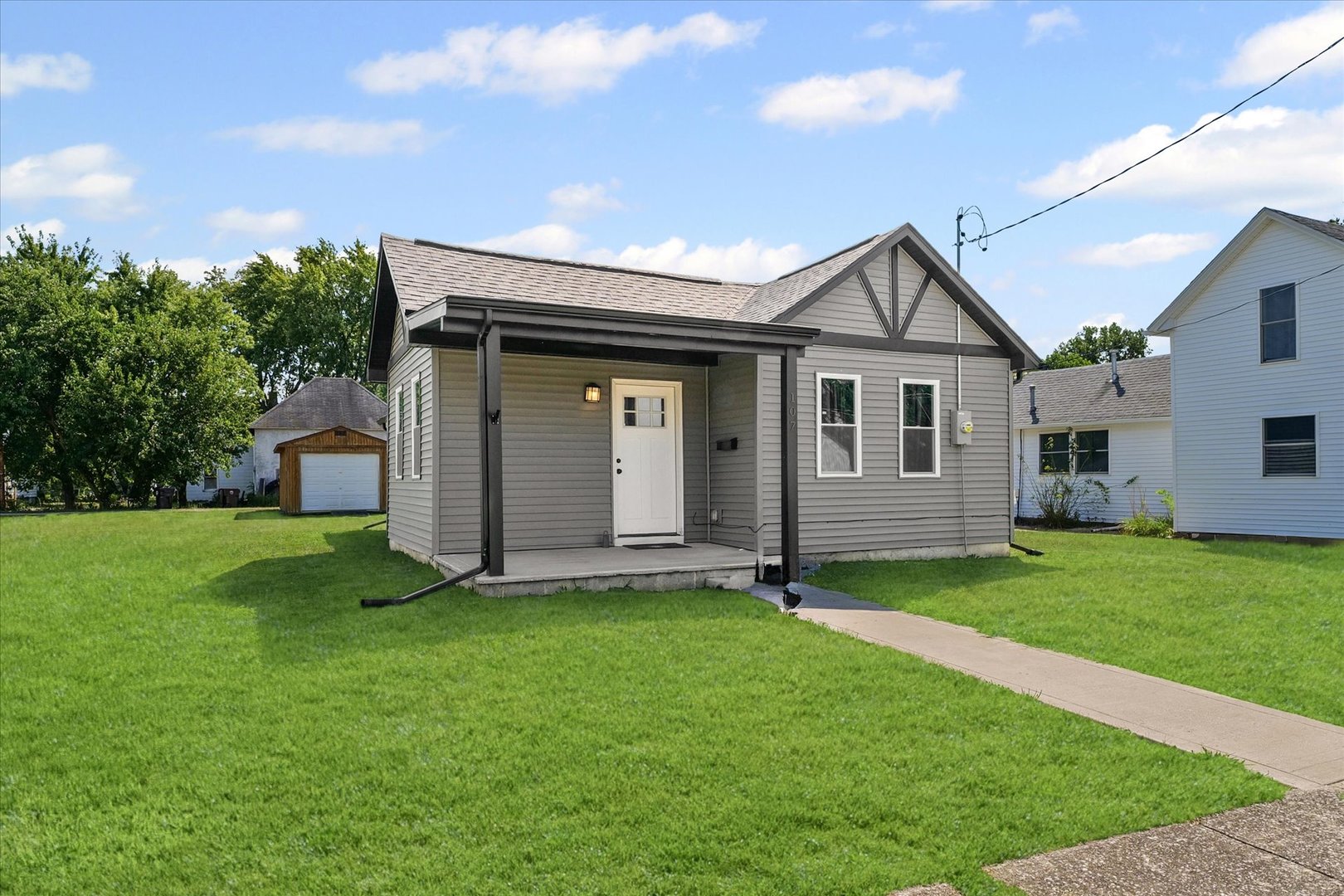 107 Front Street Fisher, IL 61843 - Photo 3 of 25 a view of a house with a yard