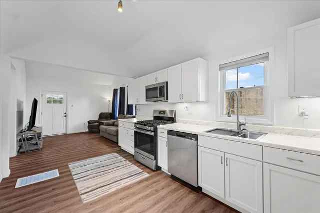 a kitchen with a sink cabinets and window