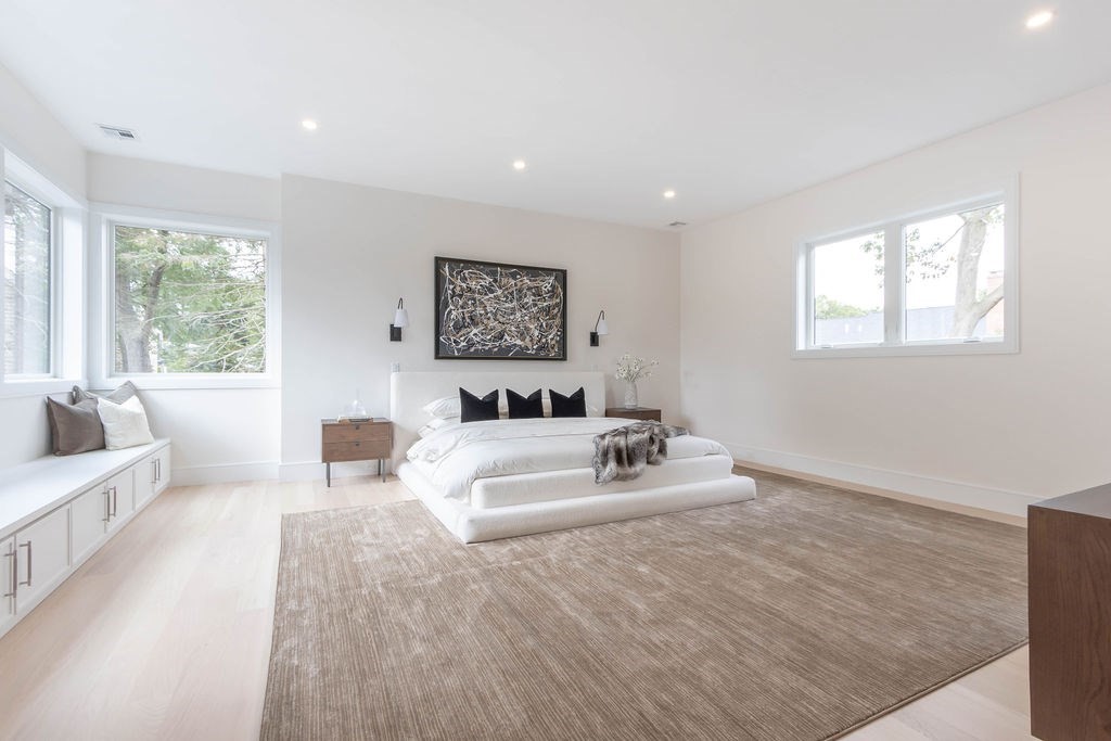 65 Mann Avenue Needham, MA 02492 - Photo 11 of 16 a spacious bedroom with a large bed couch and a window