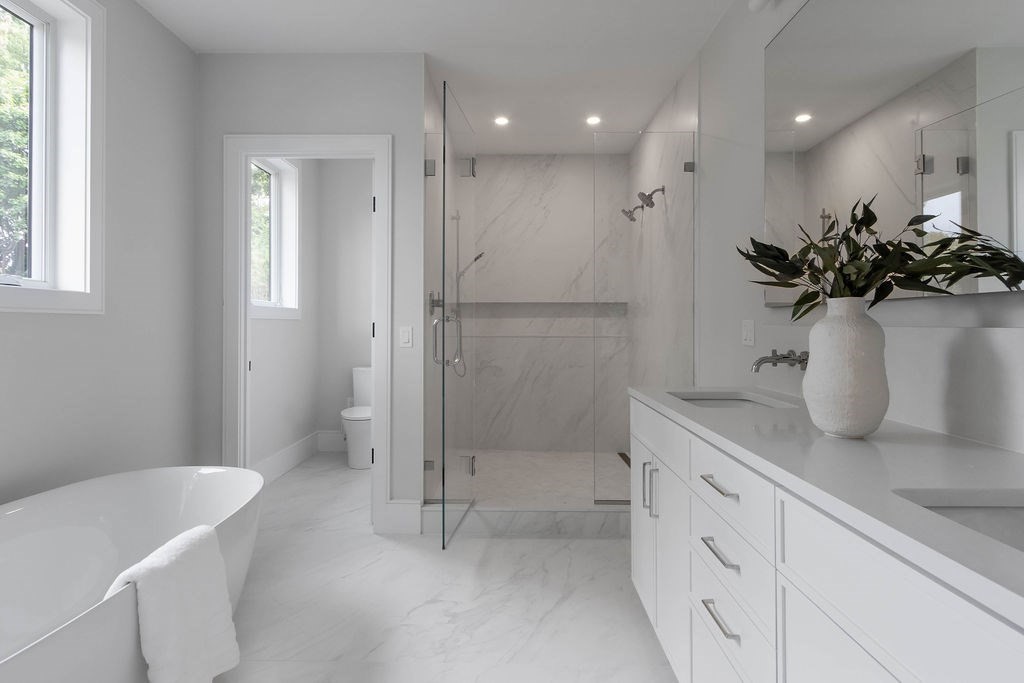 65 Mann Avenue Needham, MA 02492 - Photo 12 of 16 a bathroom with a sink a toilet and shower