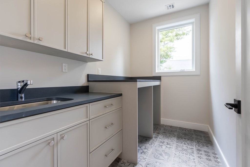 65 Mann Avenue Needham, MA 02492 - Photo 13 of 16 a kitchen with granite countertop white cabinets and a sink