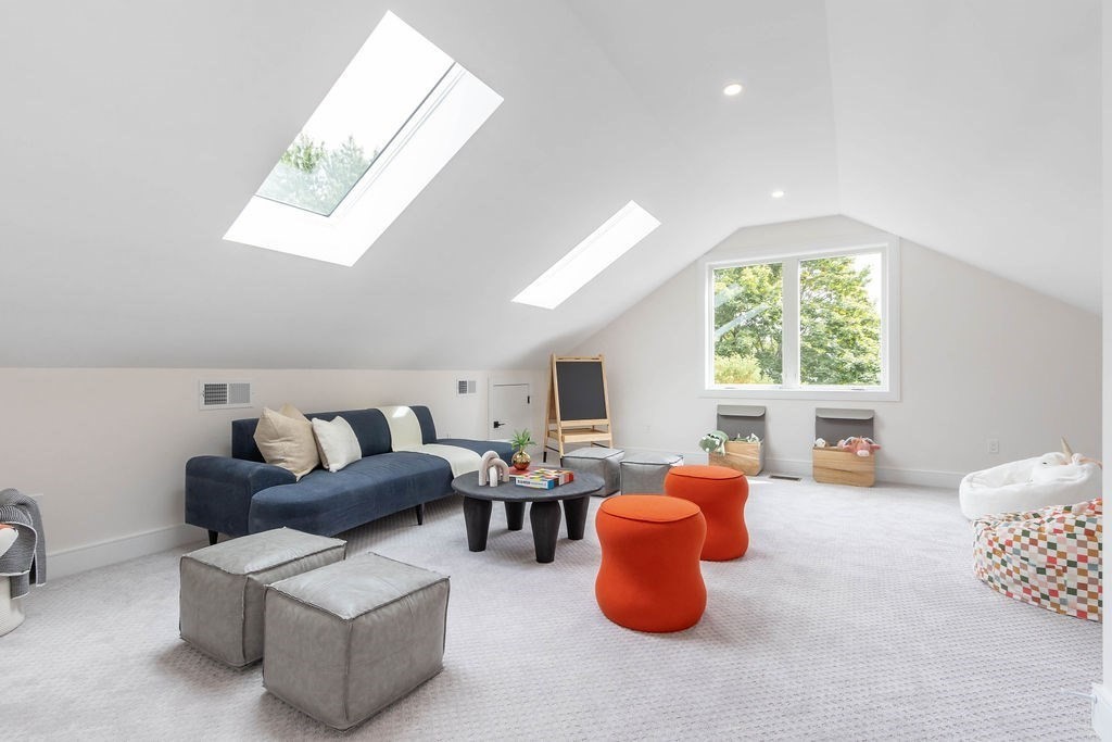 65 Mann Avenue Needham, MA 02492 - Photo 14 of 16 a living room with furniture a fireplace and a large window