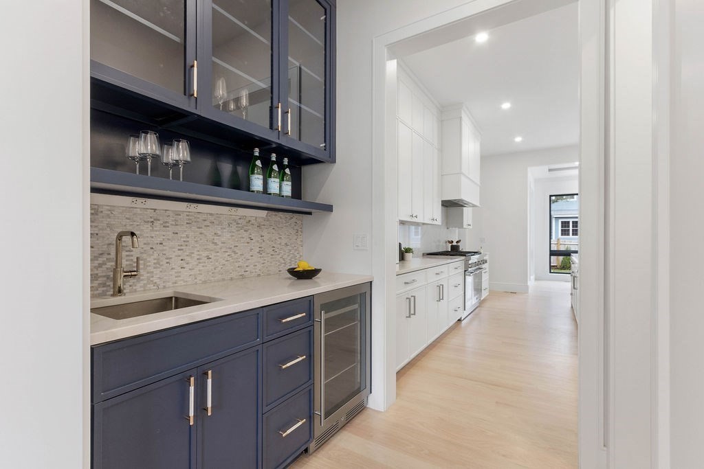 65 Mann Avenue Needham, MA 02492 - Photo 6 of 16 a kitchen with stainless steel appliances granite countertop a sink and cabinets