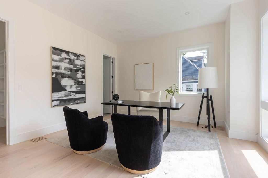 65 Mann Avenue Needham, MA 02492 - Photo 9 of 16 a view of a dining room with furniture and a potted plant