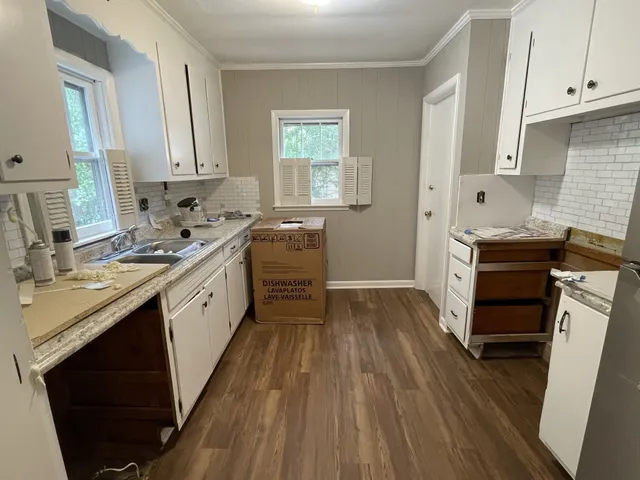 a kitchen with a sink stove and cabinets