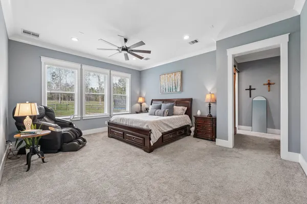 a dining room with furniture a chandelier and wooden floor