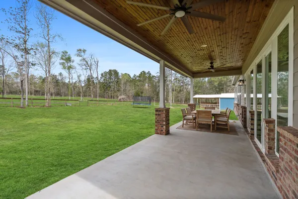 a view of a house with backyard porch and sitting area