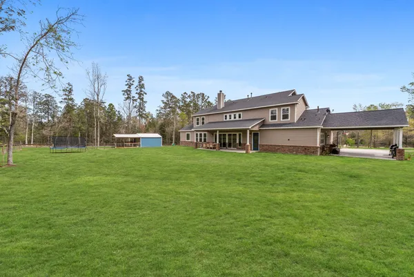 a view of a field of grass and trees