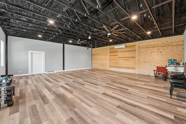 a view of a room with wooden floors and windows