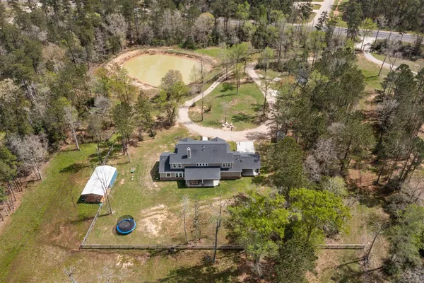 an aerial view of house with yard swimming pool and outdoor seating