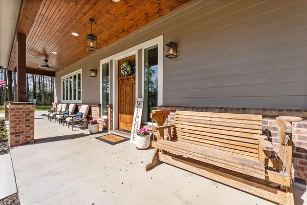 a view of a patio with table and chairs and potted plants