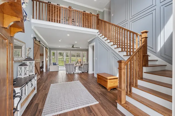 a view of entryway and hall with wooden floor