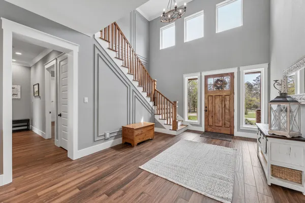 a view of entryway and hall with wooden floor