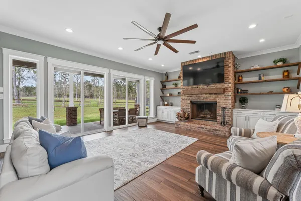 a living room with furniture a flat screen tv and a fireplace