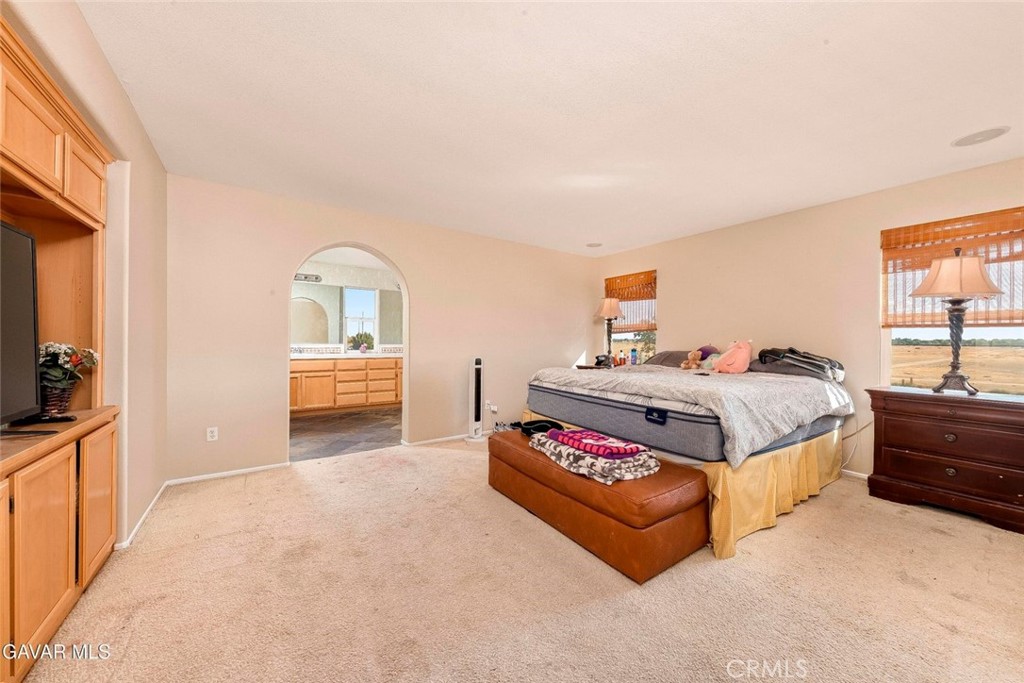 2158 Cypress Street Lancaster, CA 93535 - Photo 13 of 28 a bedroom with a bed and a potted plant