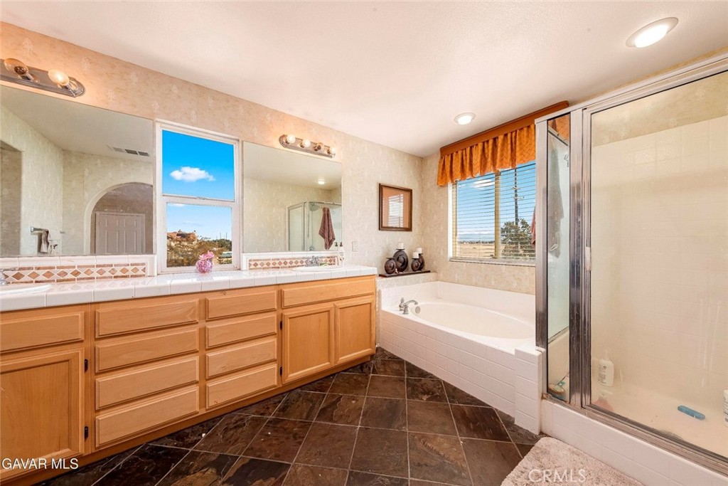 2158 Cypress Street Lancaster, CA 93535 - Photo 14 of 28 a spacious bathroom with a double vanity sink a mirror and a bathtub