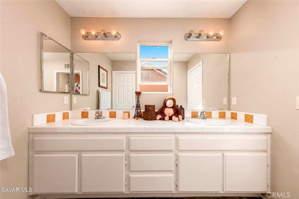 2158 Cypress Street Lancaster, CA 93535 - Photo 16 of 28 a bathroom with a sink and a mirror