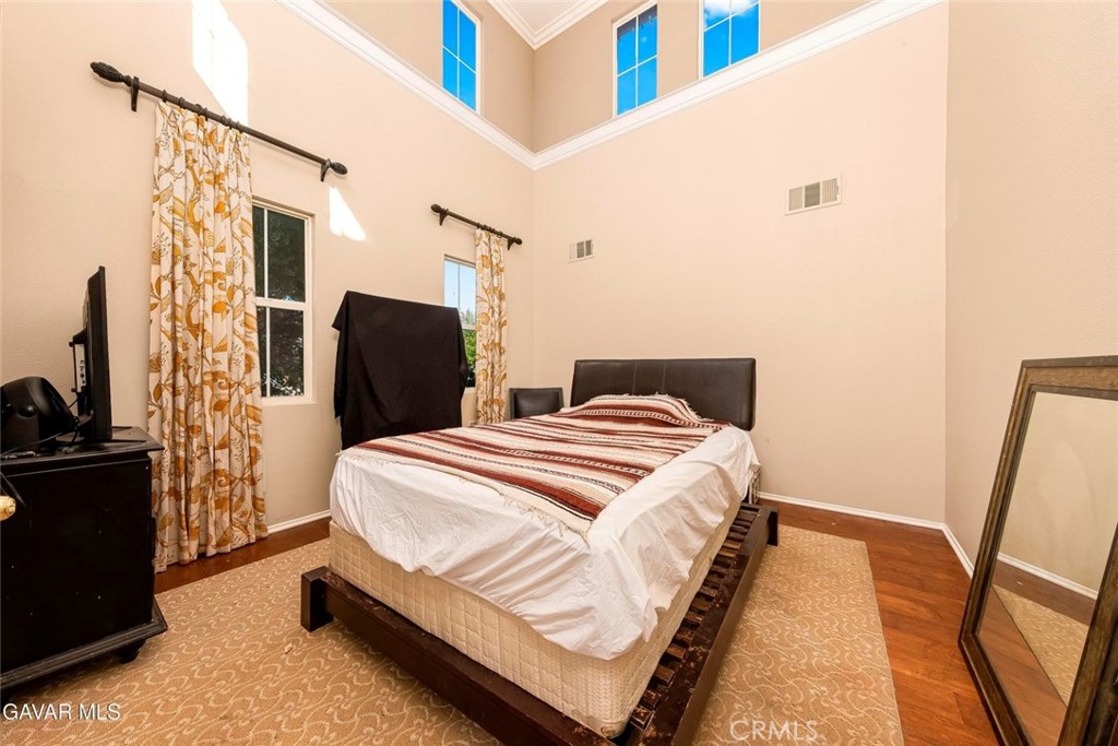 2158 Cypress Street Lancaster, CA 93535 - Photo 20 of 28 a bedroom with a bed and wooden floor