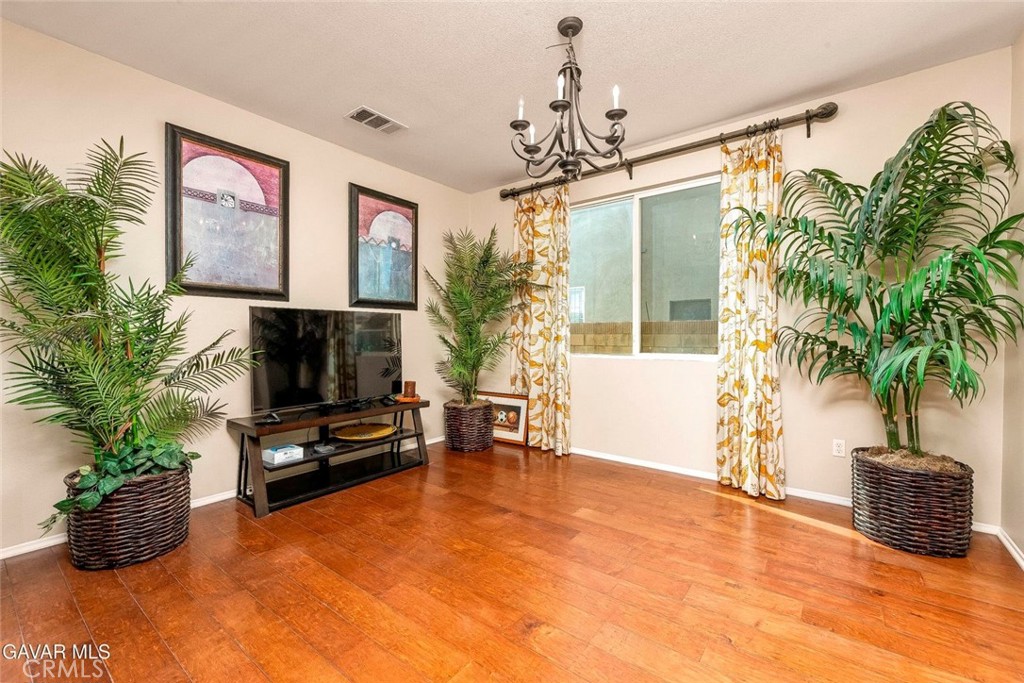 2158 Cypress Street Lancaster, CA 93535 - Photo 4 of 28 a living room with furniture a potted plant and a flat screen tv