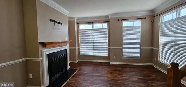 a view of a livingroom with a fireplace and window