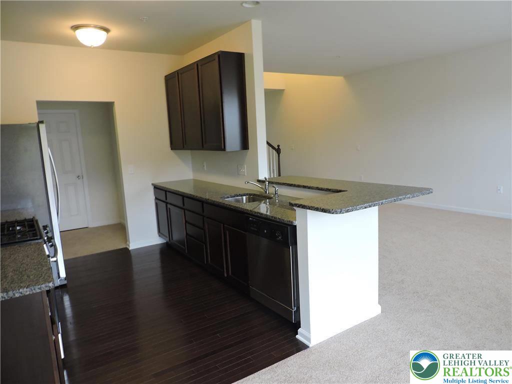 5335 Jutland Road Allentown, PA 18104 - Photo 11 of 28 a kitchen with stainless steel appliances granite countertop a sink stove and refrigerator