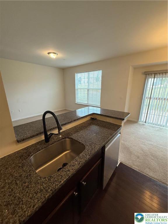 5335 Jutland Road Allentown, PA 18104 - Photo 14 of 28 a kitchen with granite countertop a sink a stove and a wooden floor