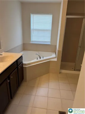 a bathroom with a tub sink and vanity