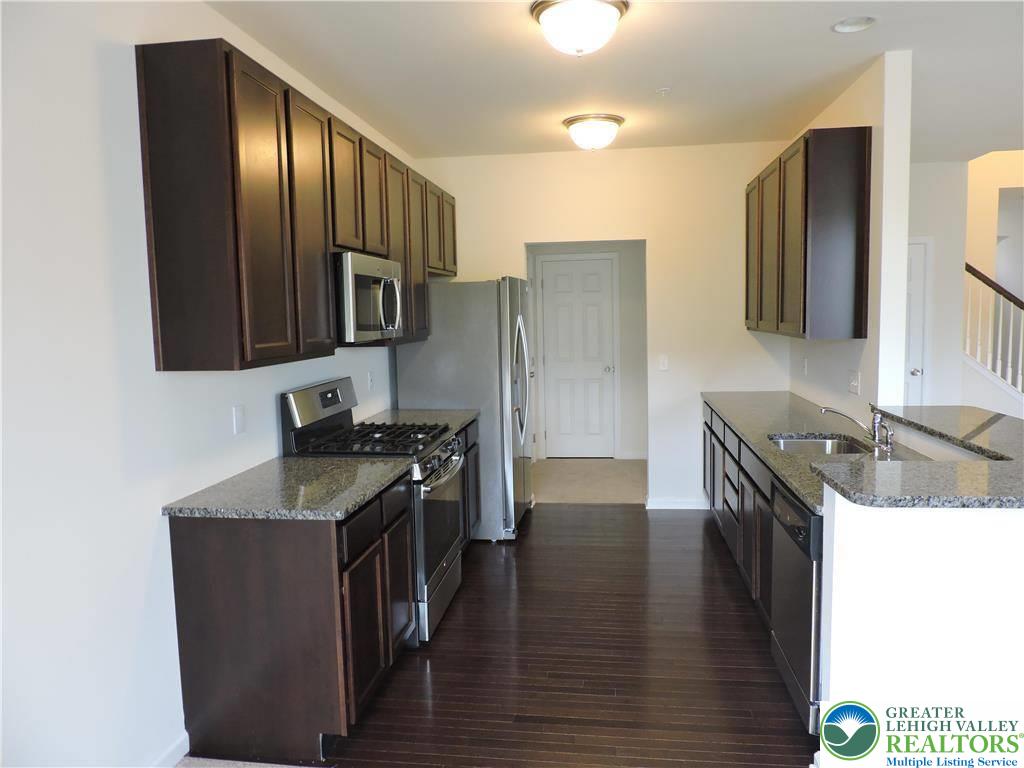 5335 Jutland Road Allentown, PA 18104 - Photo 8 of 28 a kitchen with stainless steel appliances granite countertop a stove a sink and a refrigerator