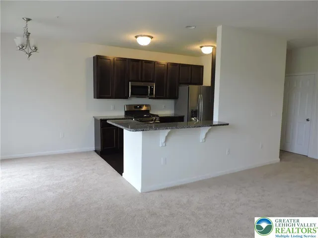 a kitchen with a sink and a stove top oven