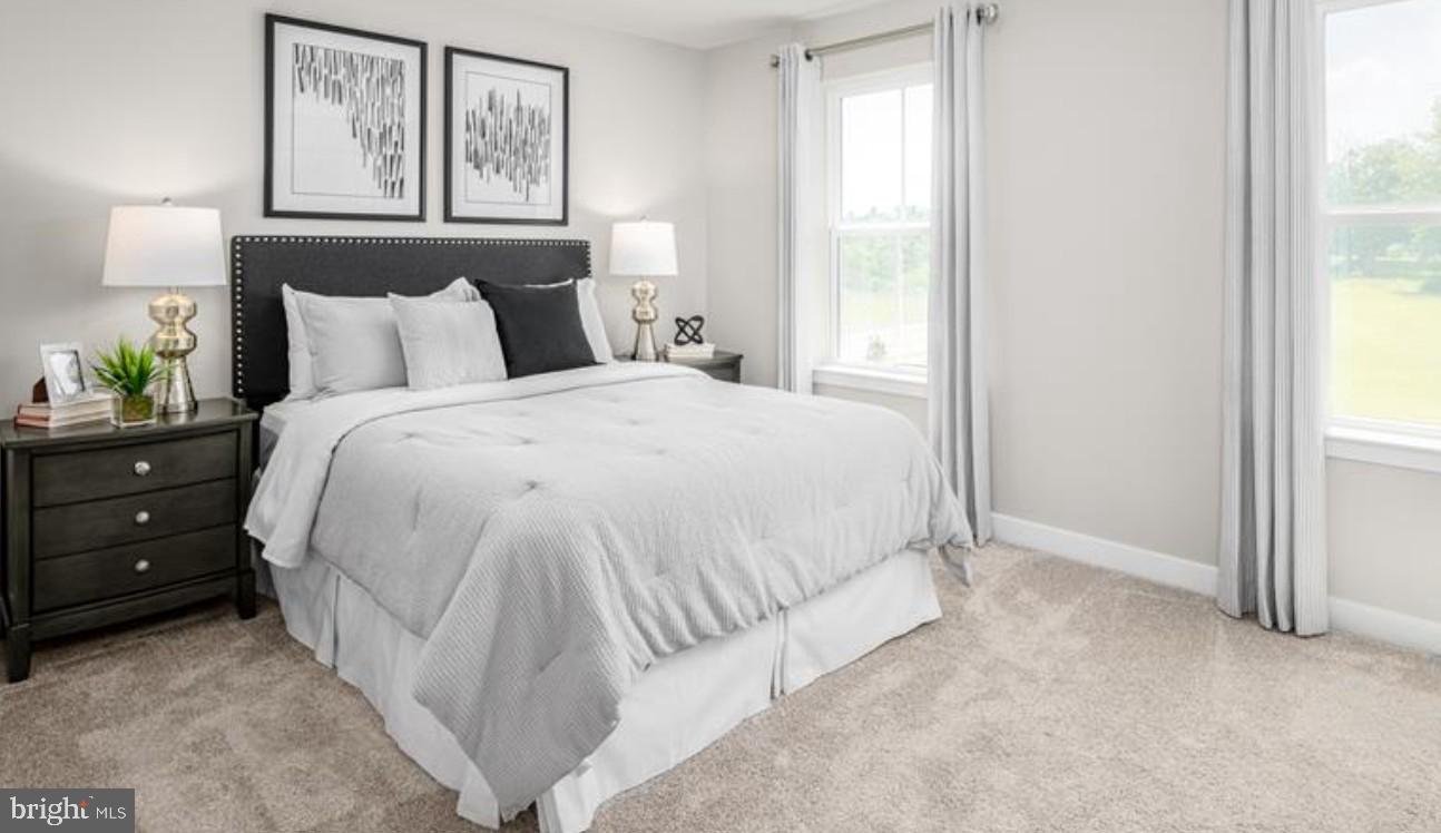 1410 Leeland Forest Road, Unit 25 Upper Marlboro, MD 20774 - Photo 13 of 21 a large bed sitting in a bedroom next to a window