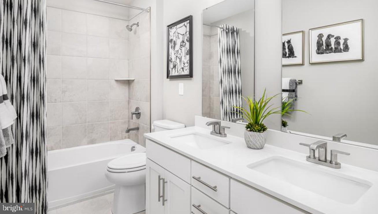 1410 Leeland Forest Road, Unit 25 Upper Marlboro, MD 20774 - Photo 16 of 21 a bathroom with a granite countertop sink a toilet and shower