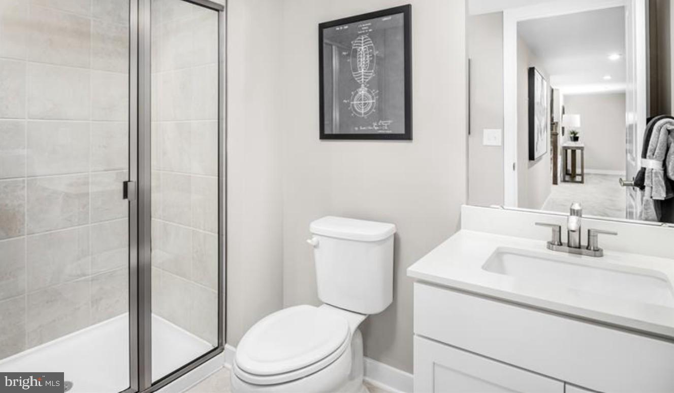 1410 Leeland Forest Road, Unit 25 Upper Marlboro, MD 20774 - Photo 20 of 21 a bathroom with a toilet sink vanity and shower