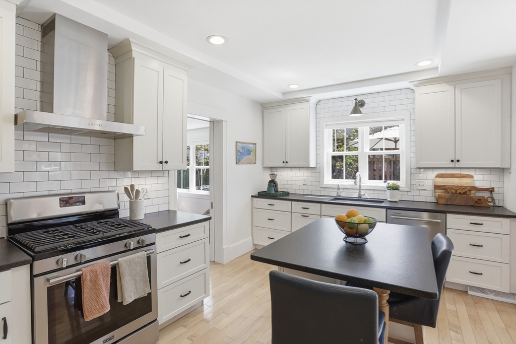 69 Potter Street Concord, MA 01742 - Photo 11 of 31 a kitchen with stainless steel appliances a sink stove and cabinets