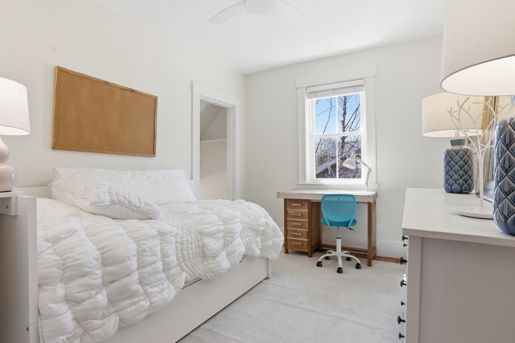 69 Potter Street Concord, MA 01742 - Photo 20 of 31 a bedroom with a bed and a table in it