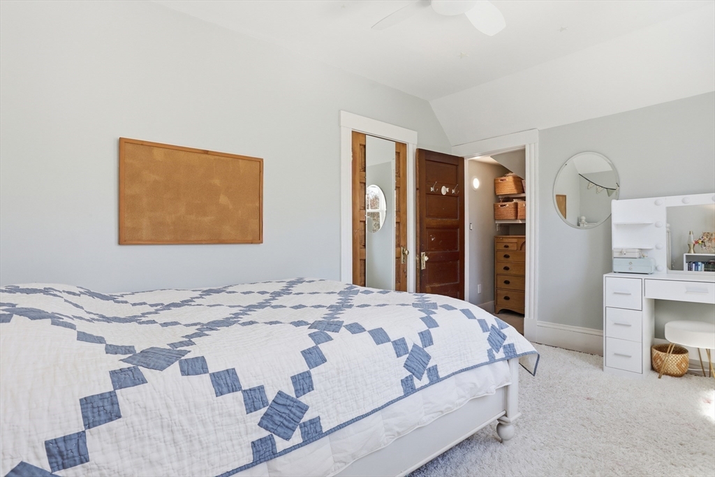 69 Potter Street Concord, MA 01742 - Photo 24 of 31 a bedroom with a bed and a painting on the wall