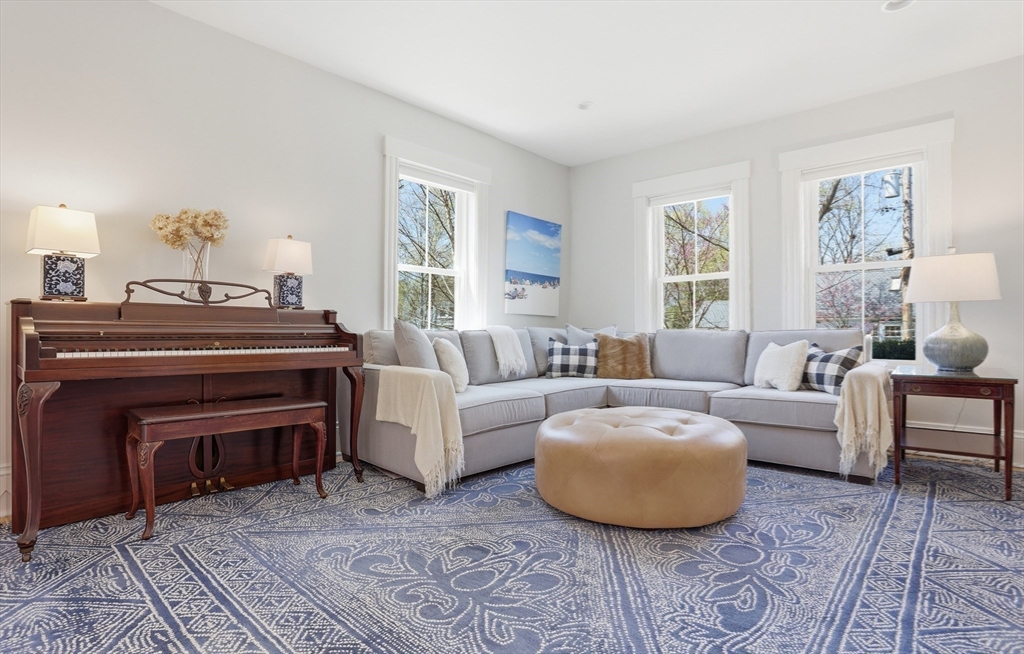 69 Potter Street Concord, MA 01742 - Photo 4 of 31 a living room with furniture a fireplace and a table