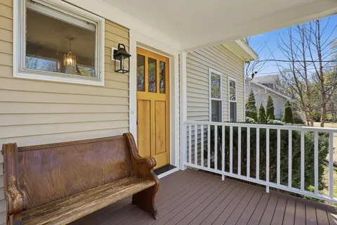 a view of a balcony with wooden floor and fence