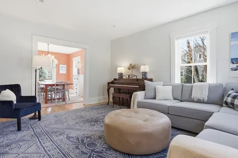 a living room with furniture and a floor to ceiling window