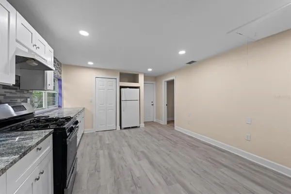 a kitchen with granite countertop a stove and a sink
