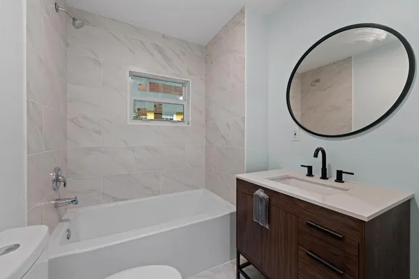 a bathroom with a sink a bathtub and a mirror