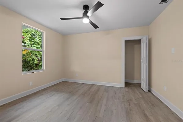 wooden floor in an empty room with a window