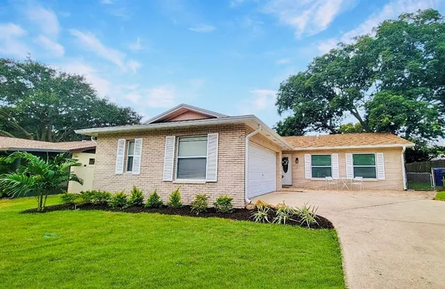 a front view of house with yard and green space
