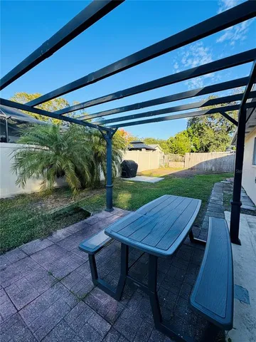a view of a porch with furniture and yard
